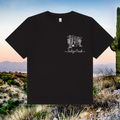 Black t-shirt with a white graphic design on a desert landscape background