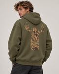 A man wearing an olive green hoodie from the back, featuring a large deer head graphic filled with a brown camouflage pattern and the words 'DEER SEASON' on the back, set against a plain light gray background.